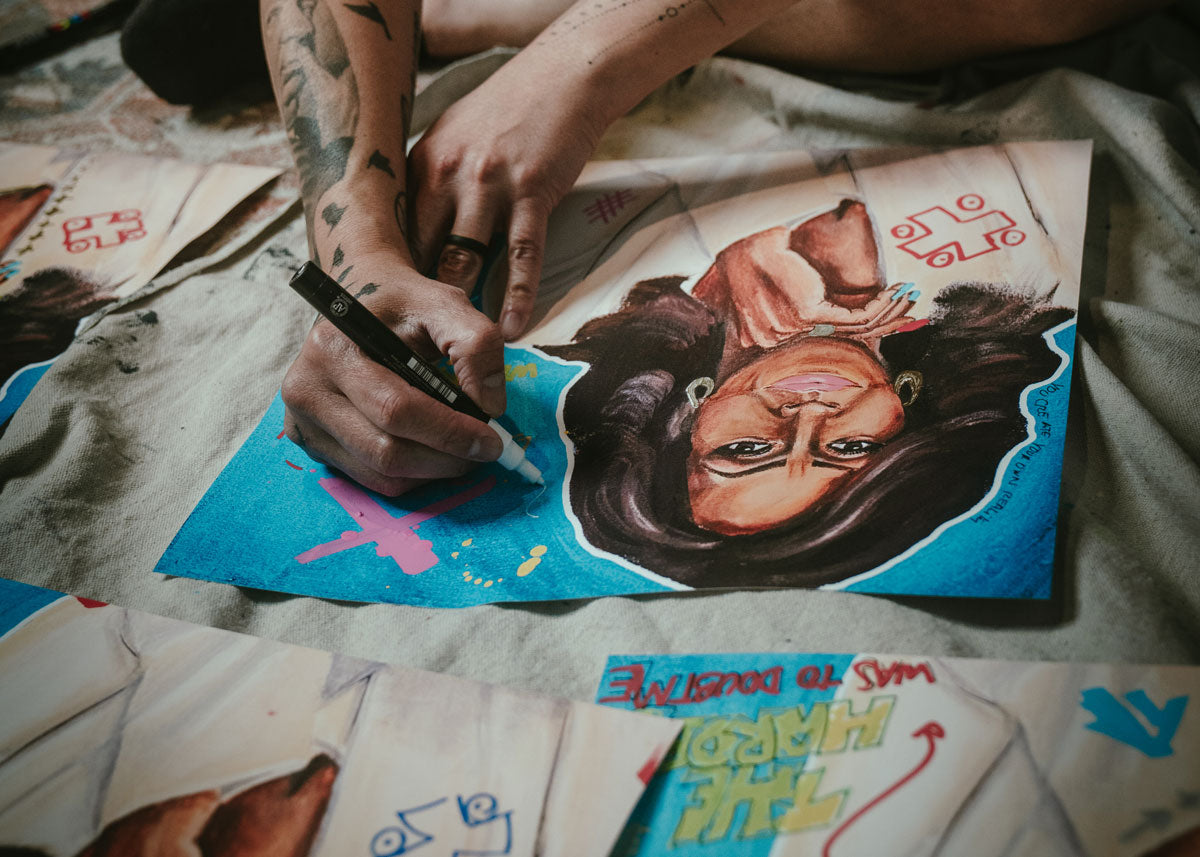 Artist Mads Suquet hand embellishing a Michelle Obama FLOTUS Forever limited edition pop art print